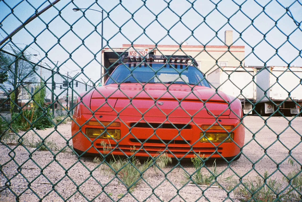 Passenger vehicle shown through a fence